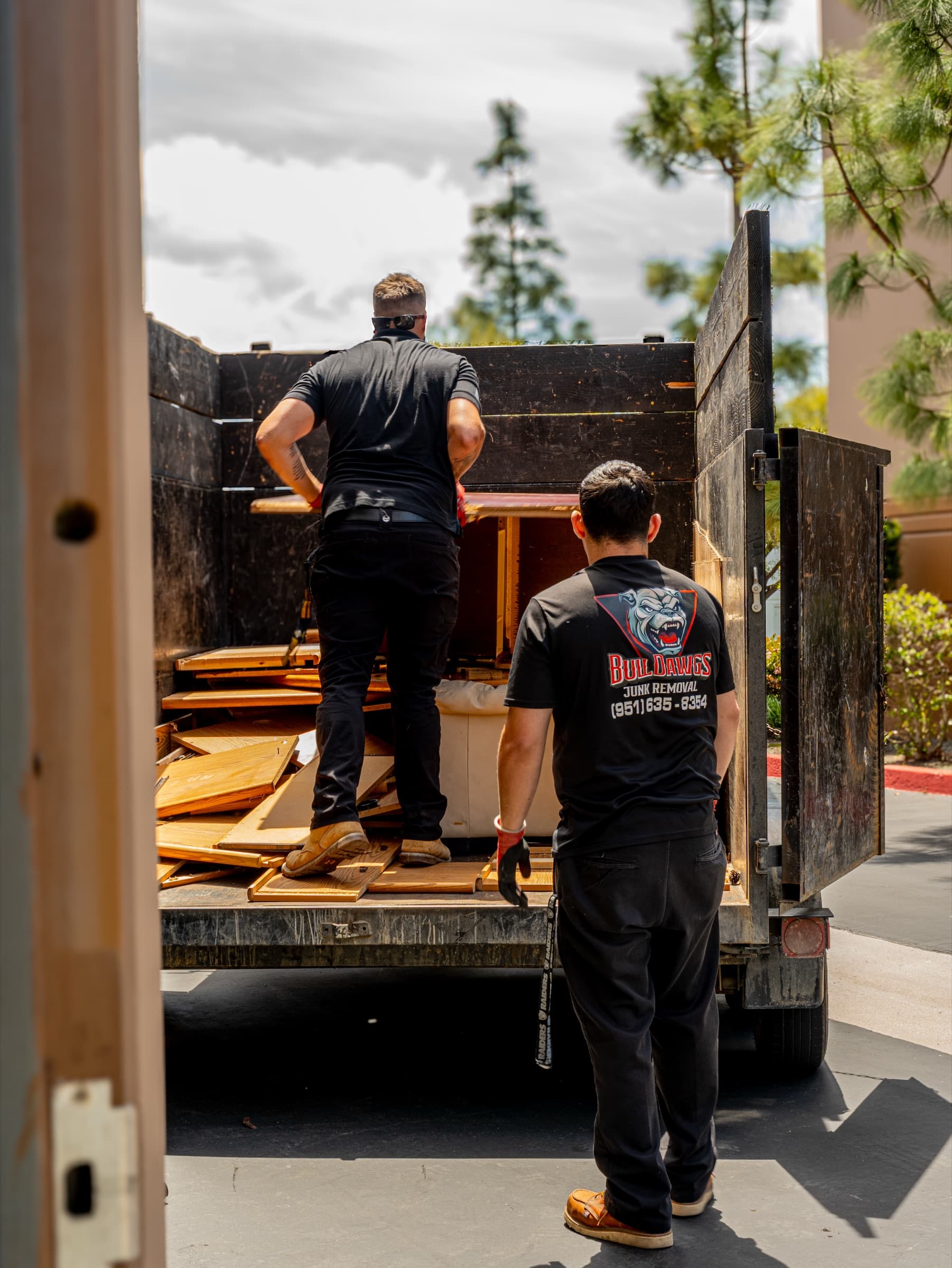BullDawgs crew loading debris onto a haul truck during a commercial cleanout in Southwest Riverside County